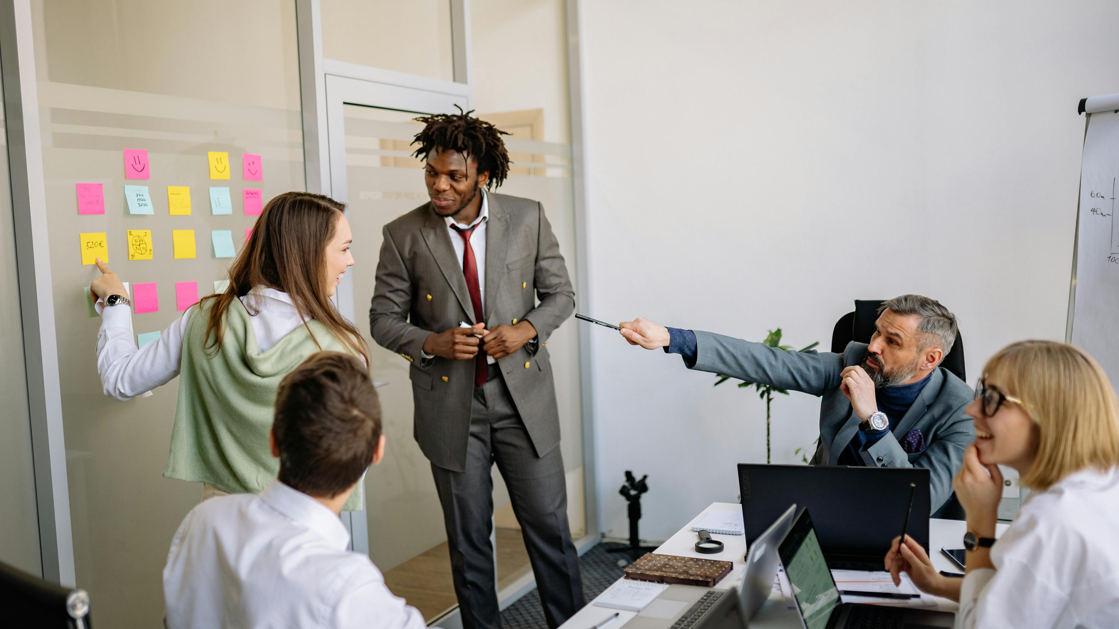 A diverse team of marketers planning a marketing funnel on a whiteboard, illustrating service-business marketing